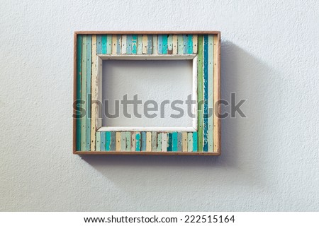 Retro style wooden picture frame hanged  on white wall