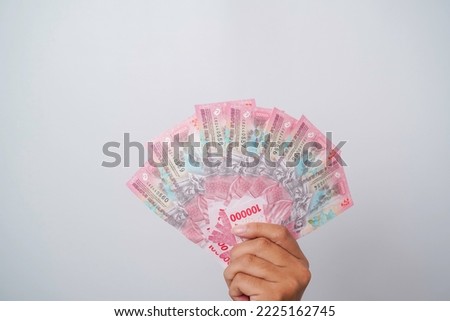 A portrait of new banknotes for Rp.100,000 issued in 2022. Indonesian rupiah currency Royalty-Free Stock Photo #2225162745
