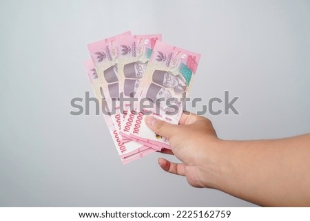 A portrait of new banknotes for Rp.100,000 issued in 2022. Indonesian rupiah currency Royalty-Free Stock Photo #2225162759