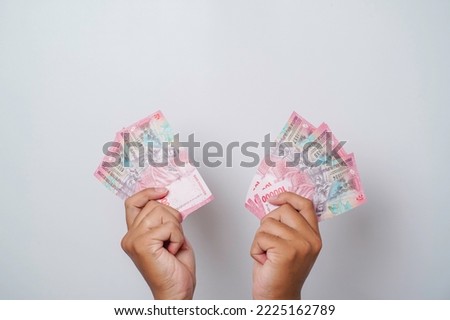 A portrait of new banknotes for Rp.100,000 issued in 2022. Indonesian rupiah currency Royalty-Free Stock Photo #2225162789
