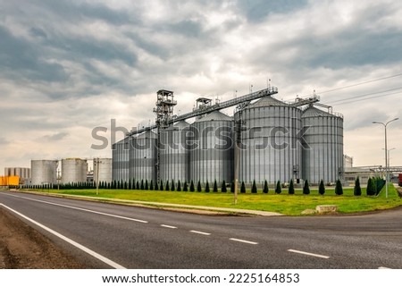 Grain elevator silos for storage and drying of grains, wheat, corn, soy, sunflower. Industrial theme Royalty-Free Stock Photo #2225164853