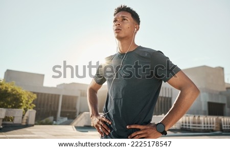 Music headphones, sunshine and fitness athlete ready for cardio exercise, marathon training or performance workout. Runner determination, blue sky flare and black man listening to radio or podcast