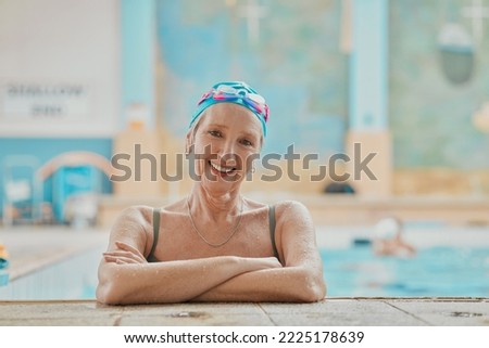 Senior woman, swimmer in water and relax in swimming pool of hotel resort for healthy elderly exercise, swim training and fun with friends. Happy elder, smile on face and retirement workout activity