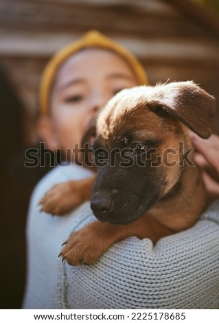 Dog, playing and child at a shelter for adoption, love and care with a pet in nature. German shepherd, happy and girl holding a young puppy at a park to play, fun and relax with bokeh background Royalty-Free Stock Photo #2225178685