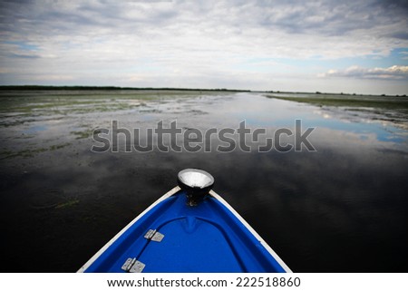 Color picture of a wooden boat on a river.