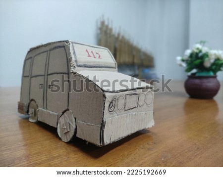 public transportation toys in Indonesia with transportation number 112, handmade toys made of cardboard.