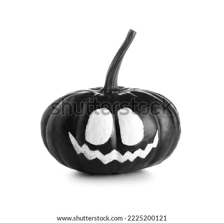 Black Halloween pumpkin with drawn face on white background