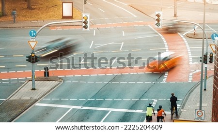 Aerial view of the city crossroads intersection junction with motion blurred traffic of cars and cyclists on the bike path Royalty-Free Stock Photo #2225204609