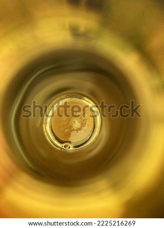 view through the neck of a brown beer bottle