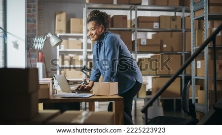Warehouse Female Inventory Manager Using Laptop Computer, Preparing a Small Parcel for Postage. Black Multiethnic Small Business Owner Working in Storeroom, Preparing Order for Client. Royalty-Free Stock Photo #2225223923