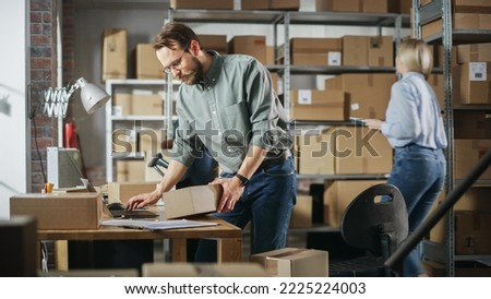 Multicultural Team of Warehouse Employees at Work in Retail Shop's Storeroom. Small Business Owners and Inventory Managers Working on Laptop, Packing Parcels for Delivery. Royalty-Free Stock Photo #2225224003