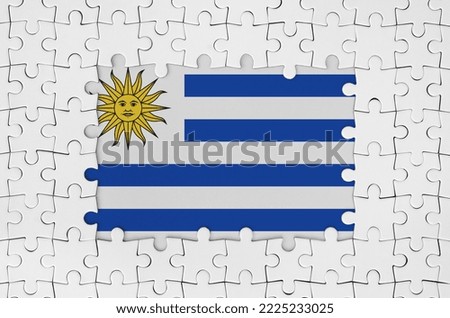 Uruguay flag in frame of white puzzle pieces with missing central parts