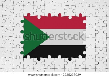 Sudan flag in frame of white puzzle pieces with missing central parts
