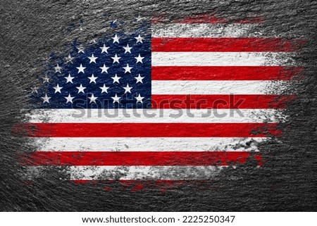 Flag of USA. American flag is painted on a stone surface. Stone background. Black slate background. Creative background