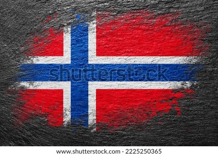 Flag of Norway. Flag is painted on a stone surface. Stone background. Black slate background. Creative background