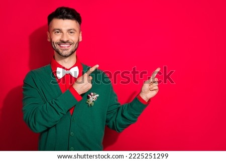 Portrait of cheerful elegant guy toothy smile indicate fingers empty space isolated on red color background
