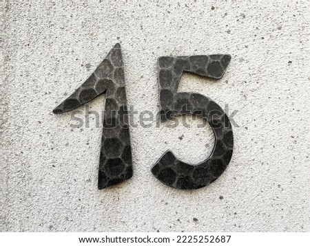 15 - house or street number fifteen on wall