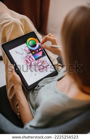 Artist or designer making new project, drawing on a graphic tablet with pencil, close-up on a screen.