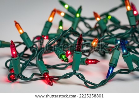 Christmas string lights with bad bulb. Holiday lighting repair, safety and decoration concept.