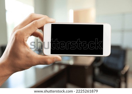 Hand of person hold phone with a blank screen