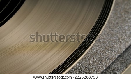 Macro shot of brown vinyl record with grooves. An old gramophone record. Vintage vinyl record player. Retro background with vinyl turntable, nostalgia.