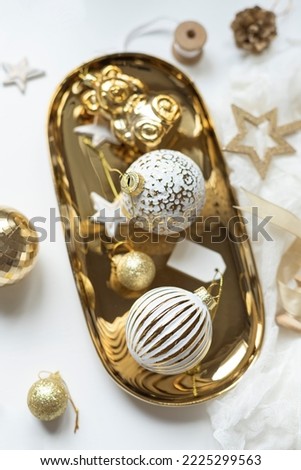 Christmas celebration concept composition with golden and white decoration on the table. Close up. 