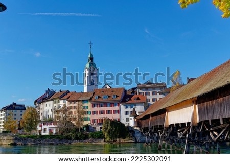 Scenic view of medieval old town of Swiss City of Olten, Canton Solothurn, with covered wooden bridge and Aare River on a sunny autumn afternoon. Photo taken November 10th, 2022, Olten, Switzerland.