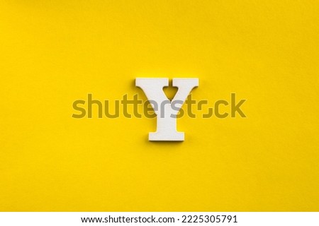 Alphabet letter Y - White wood letter on yellow colored background