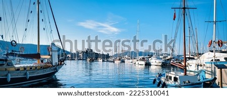 Picture of row of sailboats reflected in water, yacht port on the bay, water transport, ocean transportation, beautiful vessel in the harbor, summer vacation, active lifestyle, holiday concept