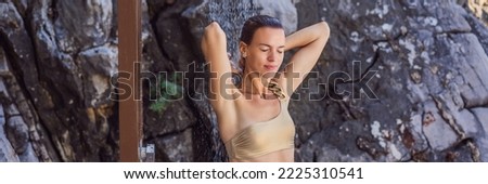 Attractive young woman enjoying and having fun under a shower on the beach BANNER, LONG FORMAT