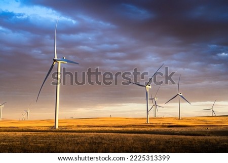 Sunset wind farm under a colourful sky producing sustainable energy on the Canadian prairies near Pincher Creek Alberta Canada.
 Royalty-Free Stock Photo #2225313399