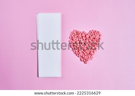 pills in the shape of a heart on a pink background with space for your text, top view stock photo