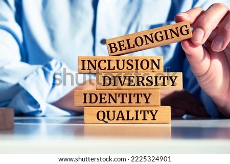 Wooden blocks with words identity, equity, diversity, inclusion, belonging on beautiful blur background. Inclusion, belonging concept.