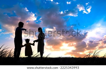 Silhouette of happy family celebrating success standing on top mountain at sunrise, Concept for Begin Again and success.