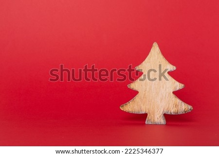 Wooden Christmas tree on color backgrond.