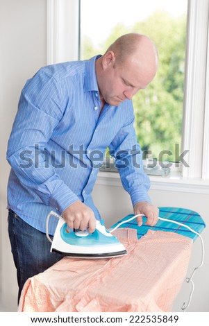 Man ironing his shirt