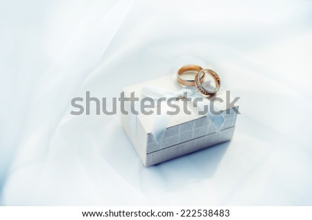 Wedding rings an the box on the background of white textile