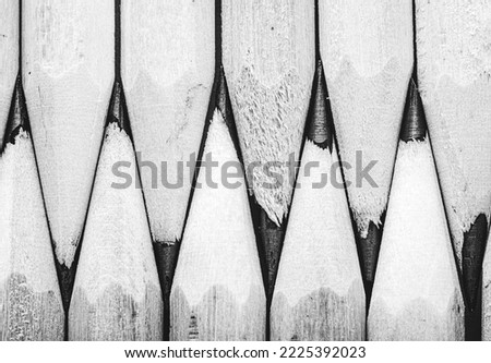 Minimalist close-up macro photography of a pencils. Black and white photography. Pencils lie next to each other Royalty-Free Stock Photo #2225392023