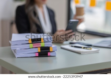 Photo of adorable young Asian lady hold telephone look screen palm keyboard shirt in home office indoors at the workplace, 