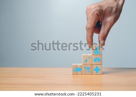 medical icon on wooden cube block on blue background,vaccination laboratories, virus protection, medical technology health and insurance concepts.