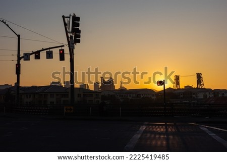 Sunrise in Portland. Traffic lights on a road in an industrial area of Portland in the early morning