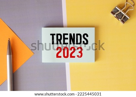Text TRENDS 2023 on white paper between white and brown spiral notepads. Royalty-Free Stock Photo #2225445031