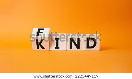 Fine and Kind symbol. Wooden cubes with words Kind and Find. Beautiful orange background. Business and Fine and Kind concept. Copy space.