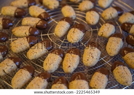 Christmas bakery: Delicious homemade hazelnut cookies for advent or christmas-freshly baked and garnished with chocolate, made with love, blurred background, close up