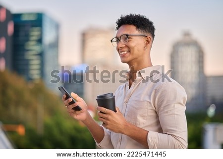 Black man, smartphone and coffee outdoor, in city and smile being trendy, casual and sunset. Gen z, travel and cellphone to connect, happy and online browse for social media, chatting and happiness Royalty-Free Stock Photo #2225471445