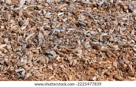 Detail view of a large pile of freshly chopped woodchips of different sizes from above, selective focus