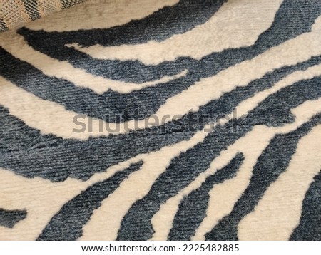 Pattern, zebra print on fur texture.  Carpet, fur covering with a picture of an imitation of a zebra print.