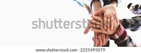 Horizontal white banner with multiethnic people joining hands in stack together - banner suitable for web or social network advertising - inclusion, diversity, youth culture, union and trust concept Royalty-Free Stock Photo #2225495079