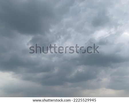Dramatic landscape of stormy sky Nimbostratus Clouds A gray Style rolls and Huge scary storm it's going to rain heavily at Bangkok, Thailand.no focus Royalty-Free Stock Photo #2225529945