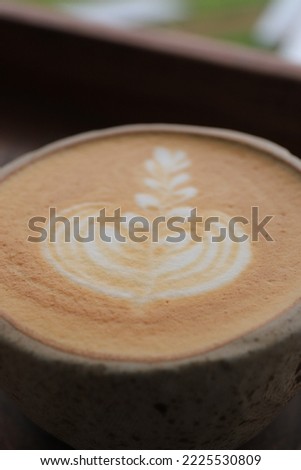 close  up a cup of cappuccino on a brown wooden table. Great for backgrounds. text or Copy space